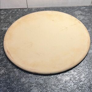 13” Retired Pampered Chef Round Pizza Stone. used a few times. FAMILY HERITAGE
